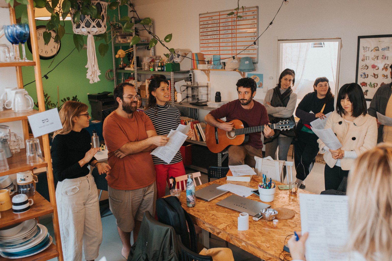 Students singing together with a guitar during a Hebrew lesson at Ulpan Bayit